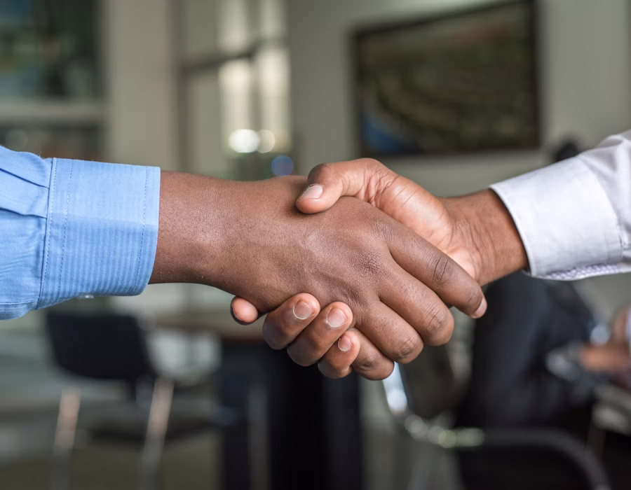 Finance advisor shaking hands with a client after loan approval
